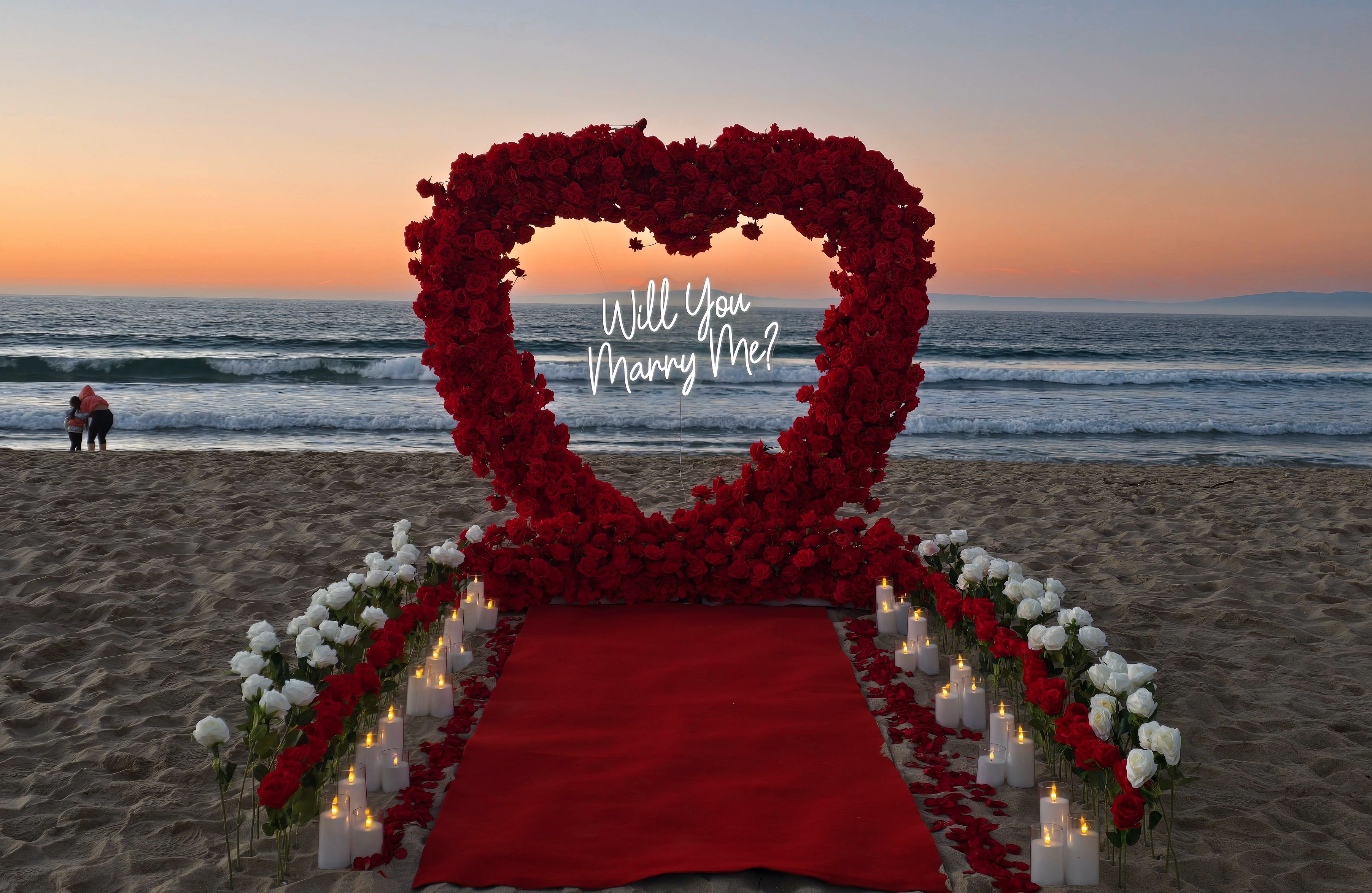 Bay Area Beach Proposal Event with tens of dozens of roses, candles, petals, and a heart arch