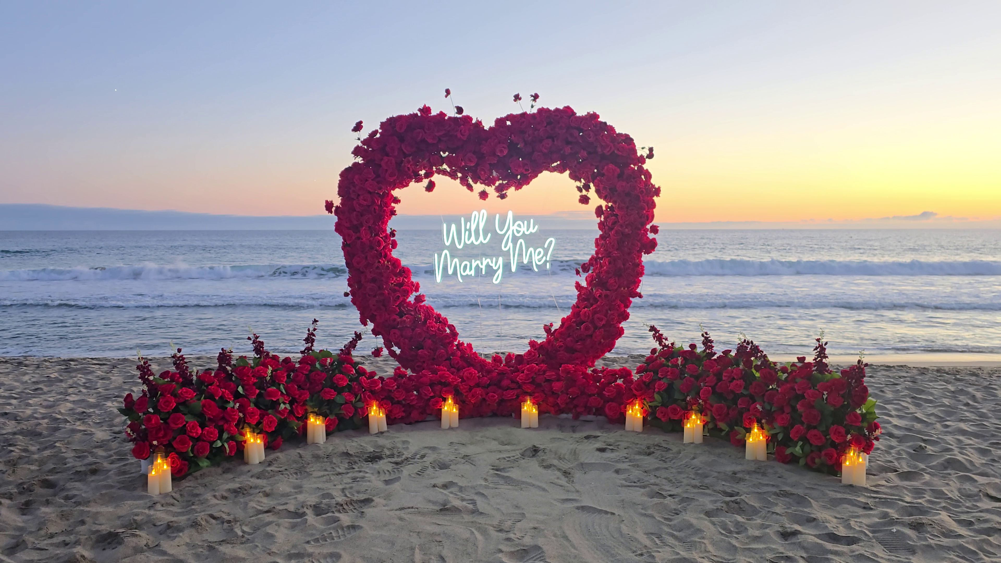 The Blooming Heart – red rose heart arch proposal setup at Half Moon Bay