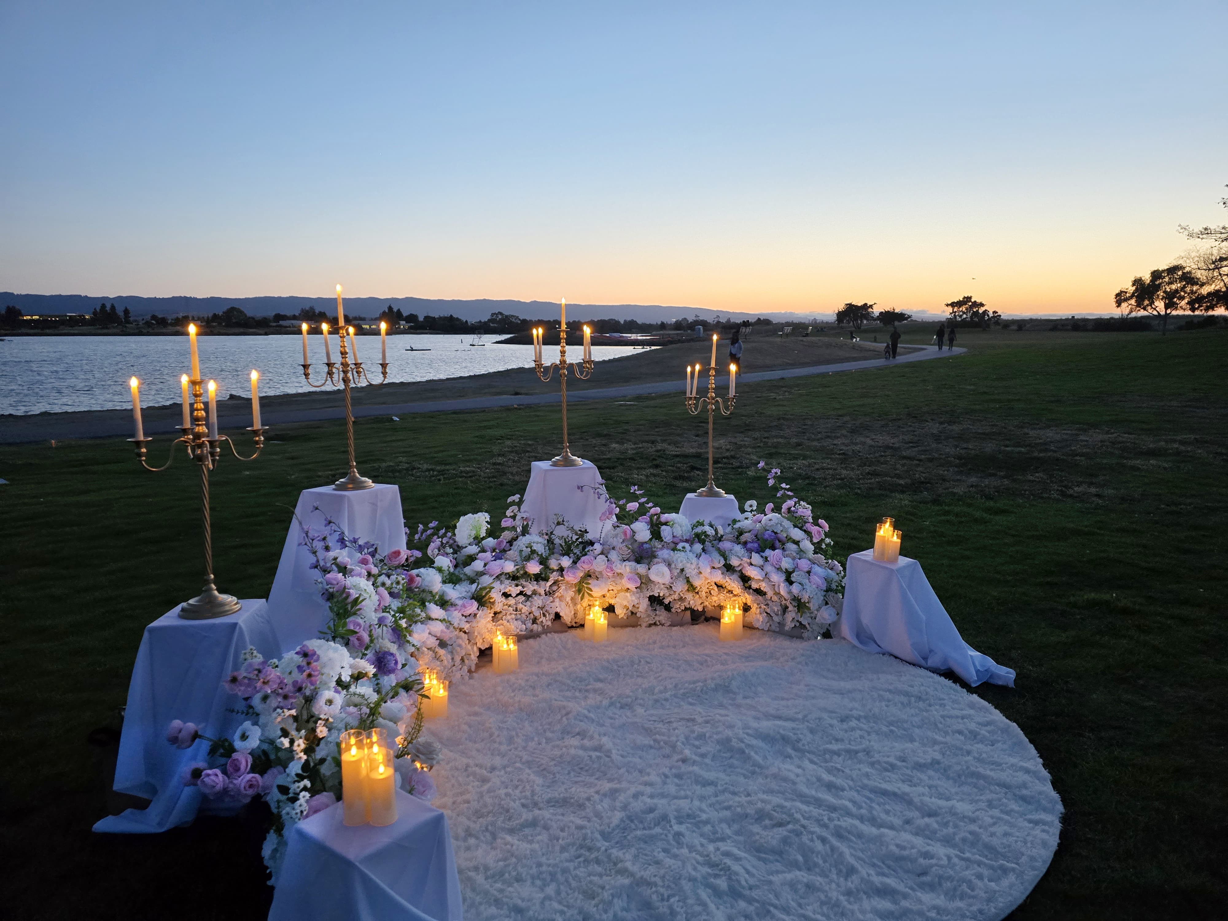 The Enchanted Romance – side view showing the candelabras, grounded florals, and rug at twilight