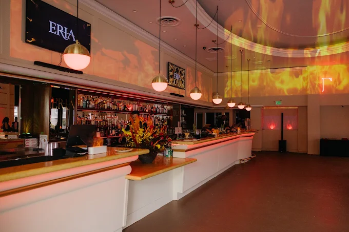 ERIA Marina's bar transformed with dramatic amber and orange lighting for an evening event