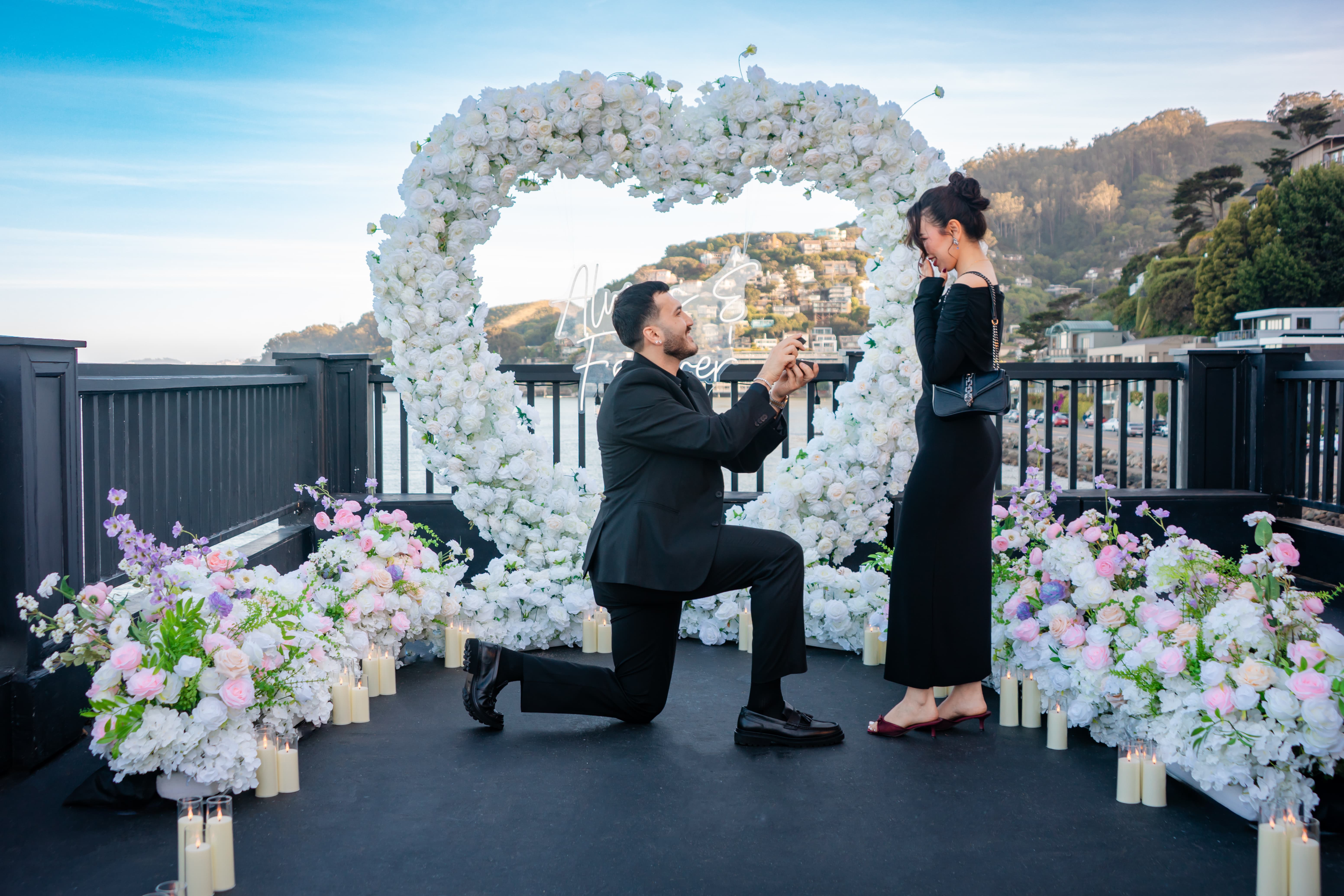 The Blooming Heart – proposal moment at Eria Sausalito with floral heart arch and candlelight