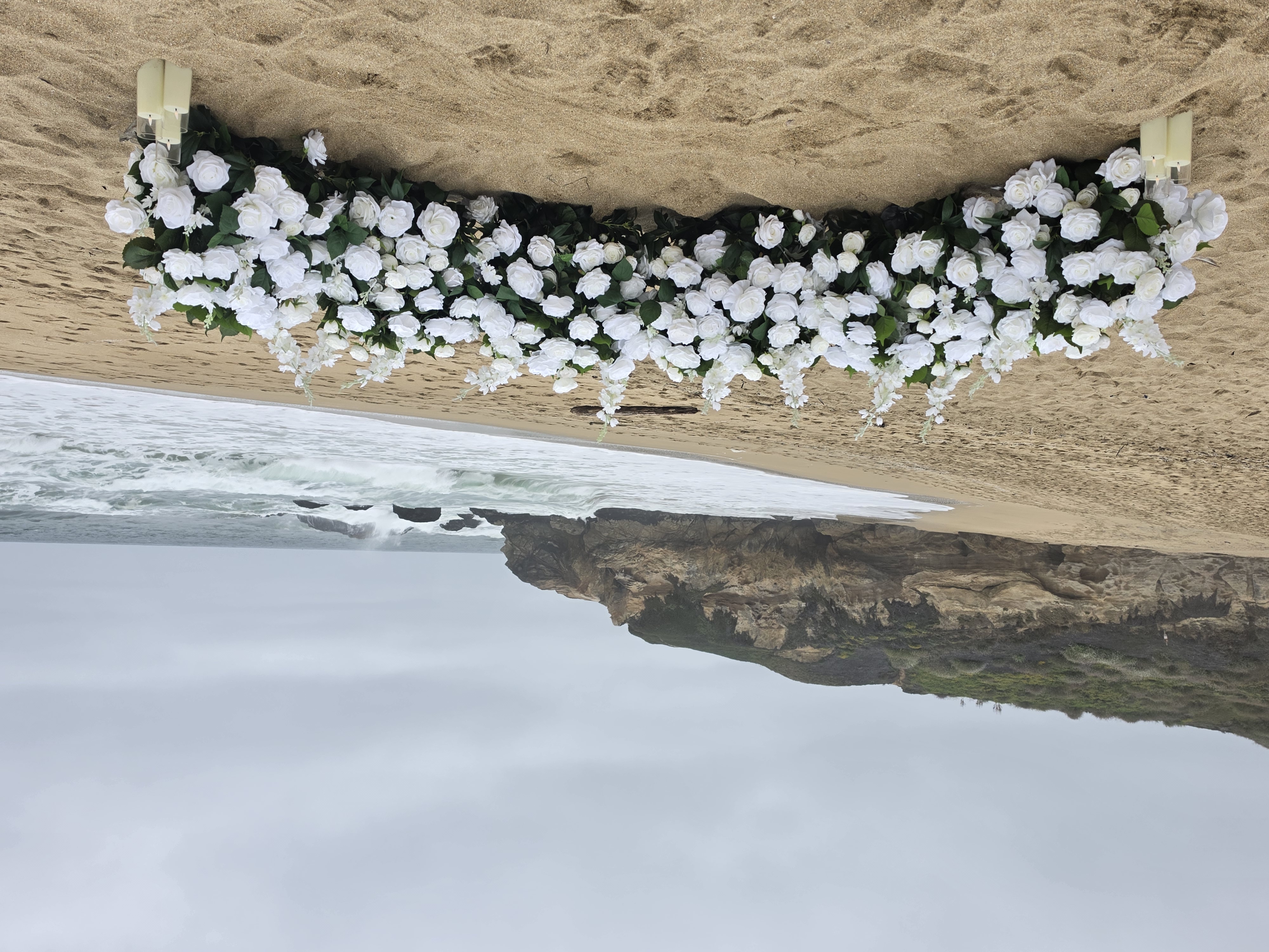 The Intimate Promise – white grounded florals with candles at Montara State Beach