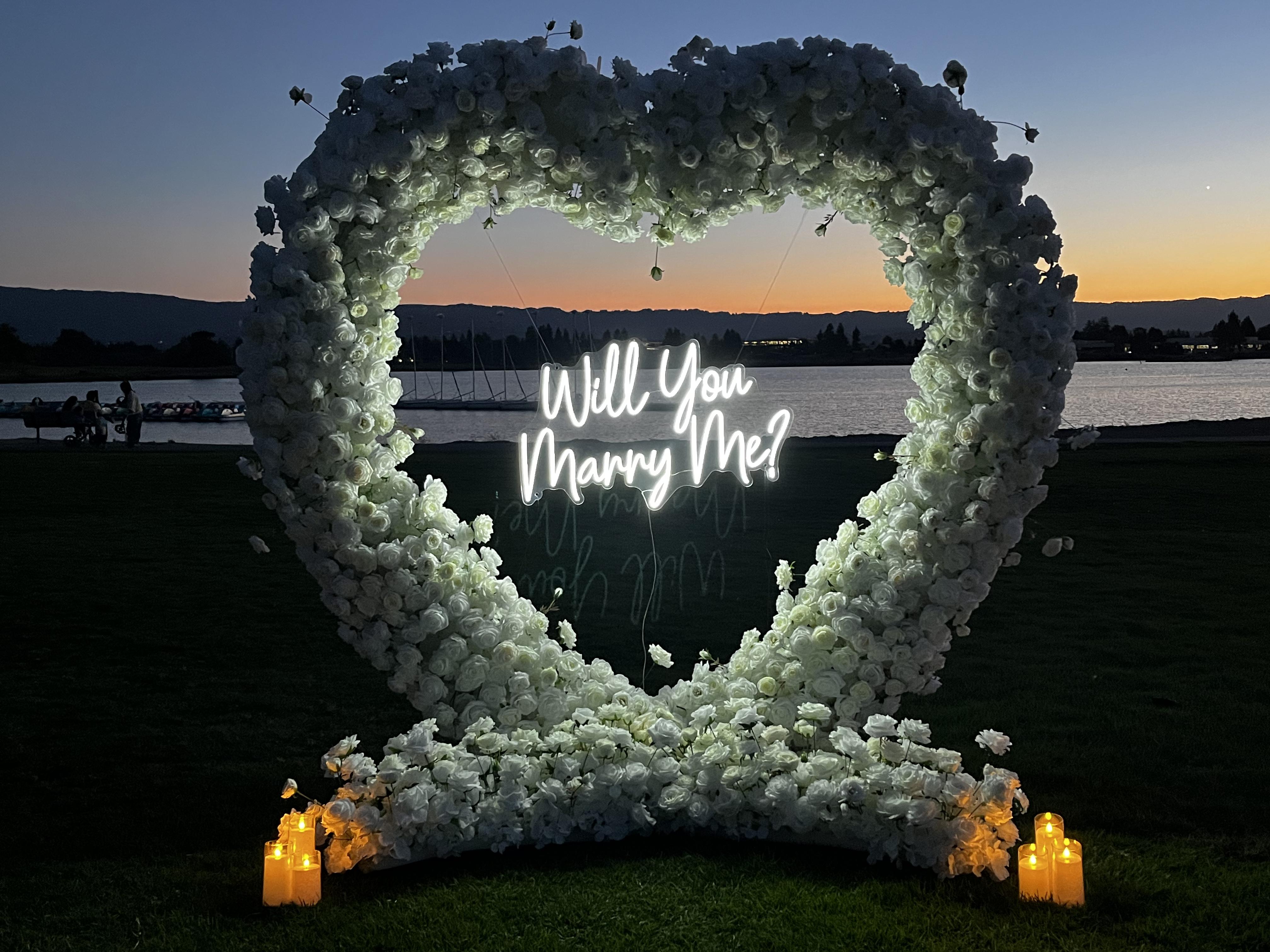 Romantic Mountain View Shoreline park proposal decoration with floral arch and candles