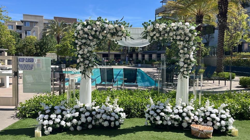 Square Arch Bay Area proposal setup with grounded florals, picnic basket, candelabras and candles
